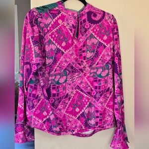 Anthropologie Tiny Brenan Flutter-Sleeve Top in a pink and purple pattern.